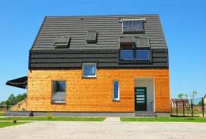 Modern House Exterior Design. New Building House Energy Efficiency Solution Concept Outdoor. Solar Energy Solar Water Heater Solar Panels Skylights Ventilation Installed on Asphalt Shingles Roof. Solar panels.